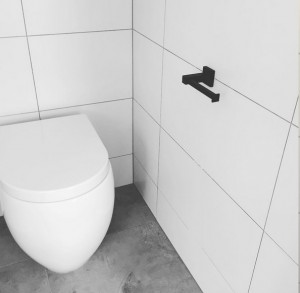 meir matte black toilet roll holder with concrete flooring    